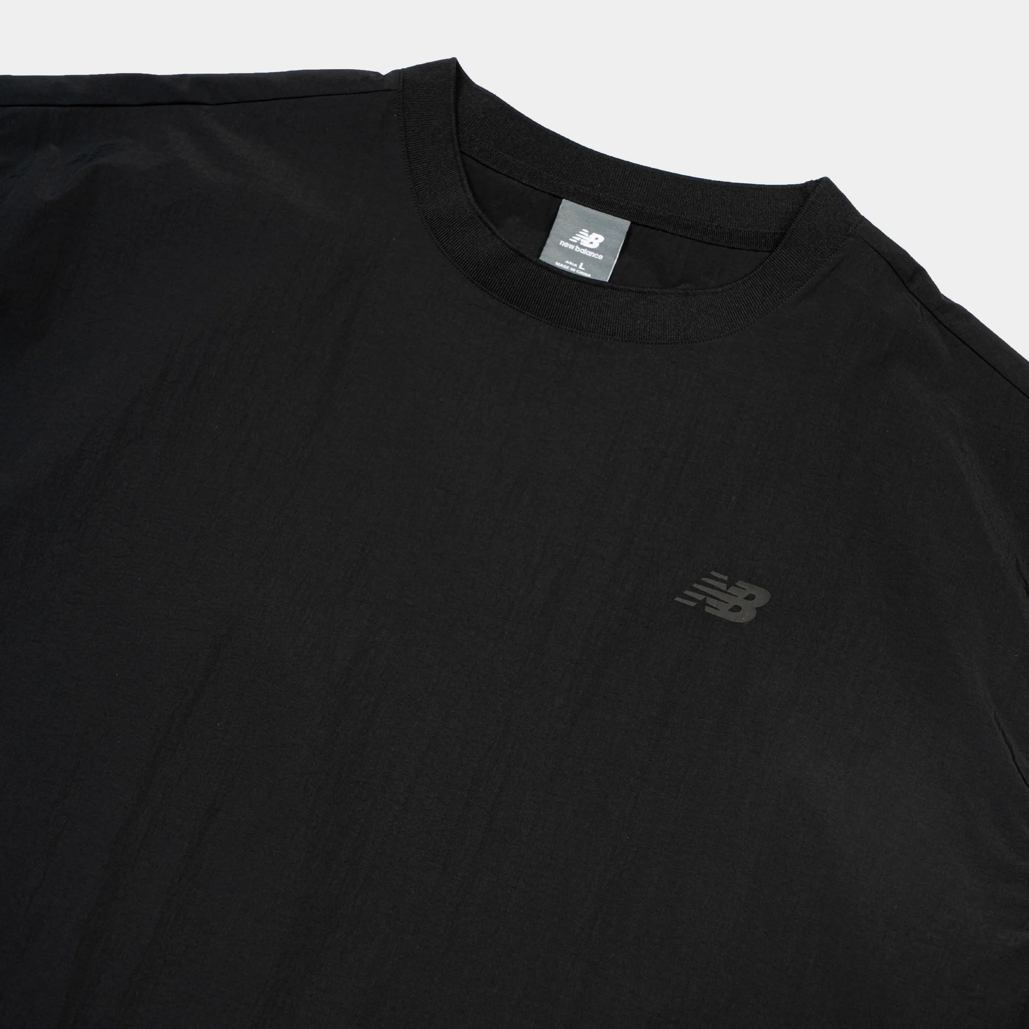 New Balance NBX Shifted 2 Woven Tee - Image 3